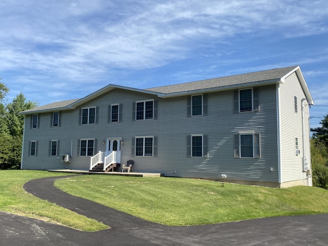 back of house with a lawn