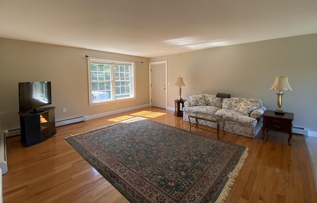 living room featuring a baseboard radiator and light hardwood / wood-style floors