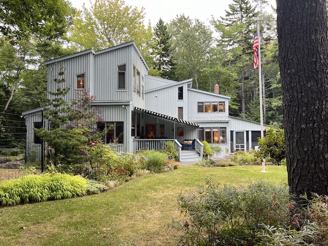 rear view of house with a yard