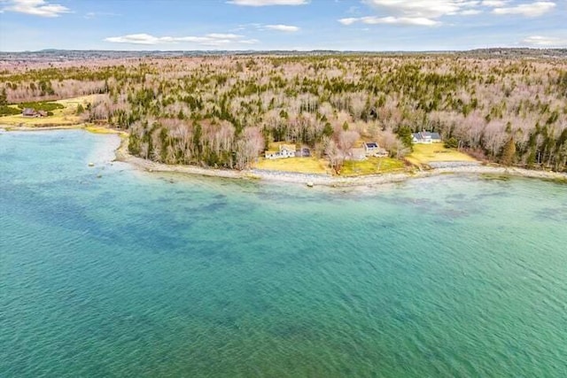 birds eye view of property featuring a beach view and a water view