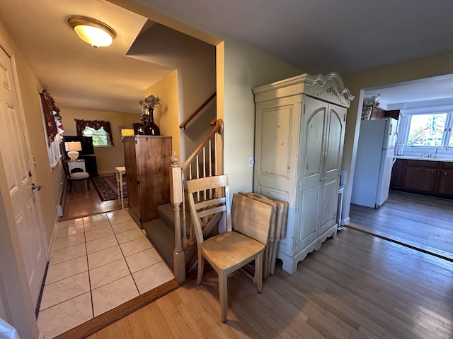 hall featuring light hardwood / wood-style floors and sink