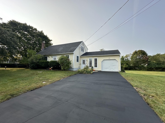 view of front of property featuring a garage and a front yard