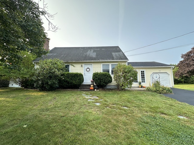 view of front facade with a garage and a front lawn