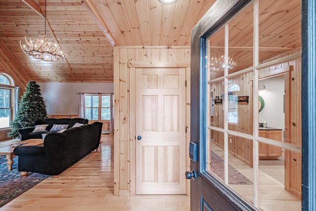 interior space with wooden ceiling, vaulted ceiling, and hardwood / wood-style flooring