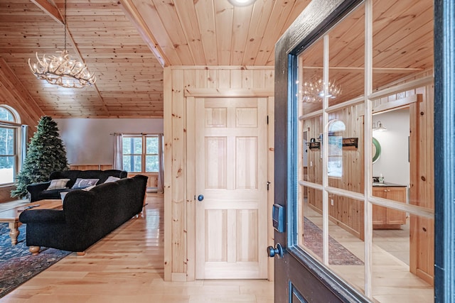 interior space featuring baseboard heating, wood ceiling, an inviting chandelier, and wood finished floors