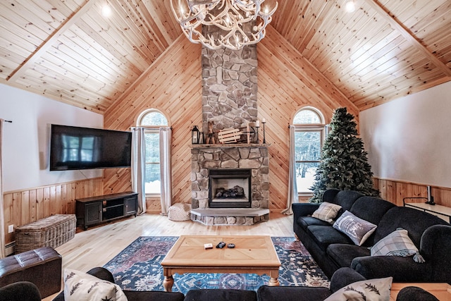 living room featuring an inviting chandelier, a wainscoted wall, wood ceiling, wood finished floors, and wood walls
