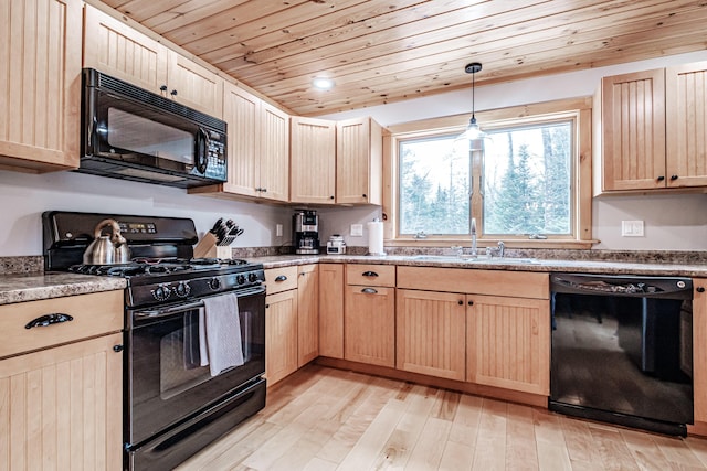 kitchen featuring light brown cabinets, a sink, wood ceiling, black appliances, and light wood finished floors