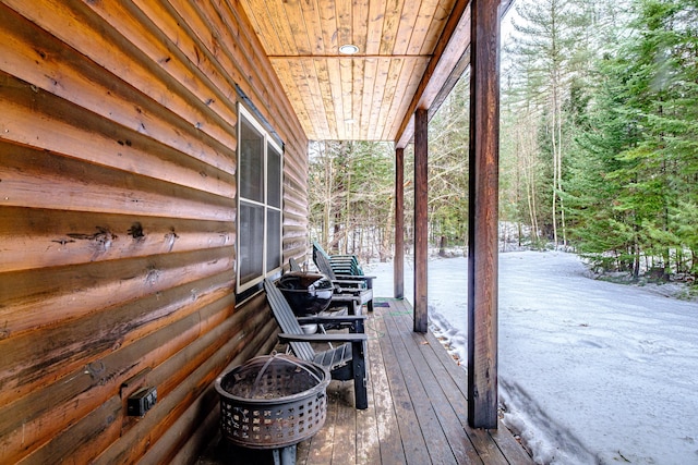 wooden terrace featuring a wooded view