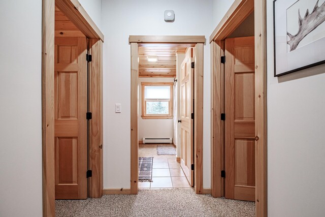 hallway with light colored carpet, wood ceiling, and a baseboard heating unit