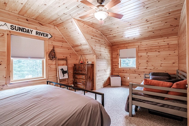 carpeted bedroom with lofted ceiling, multiple windows, wooden walls, and wood ceiling