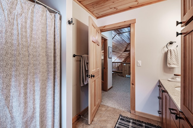 bathroom with tile patterned floors, vanity, and wood ceiling