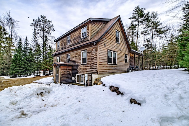 view of snow covered rear of property