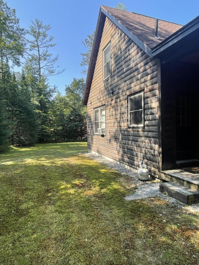 view of side of home with a yard and cooling unit
