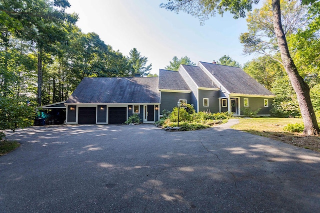 view of front facade featuring a garage and a carport