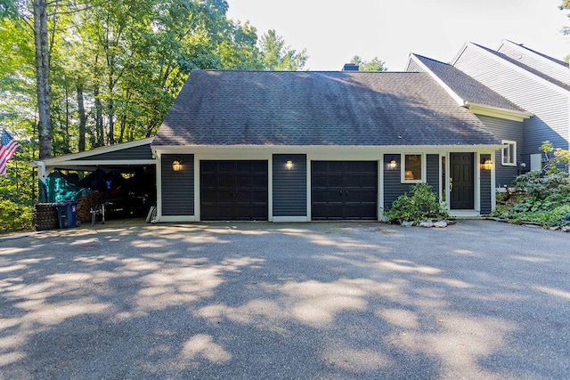 view of front of home with aphalt driveway, a garage, and roof with shingles