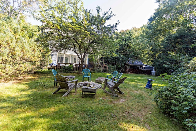 view of yard with an outdoor fire pit