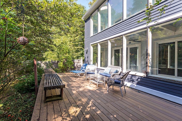 wooden deck featuring outdoor lounge area and a sunroom