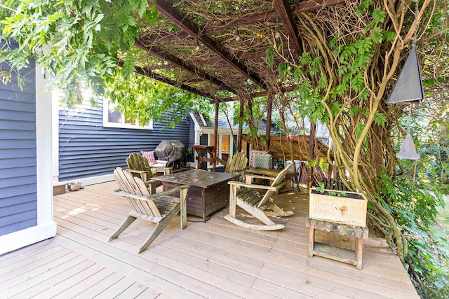 wooden terrace featuring a fire pit