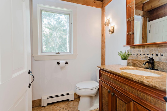 bathroom with toilet, baseboard heating, vanity, tile patterned flooring, and backsplash