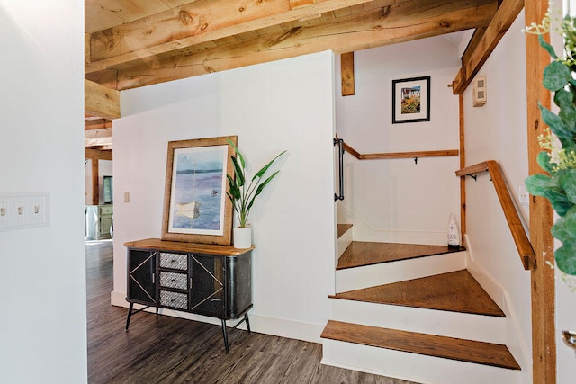 staircase featuring hardwood / wood-style flooring and beam ceiling