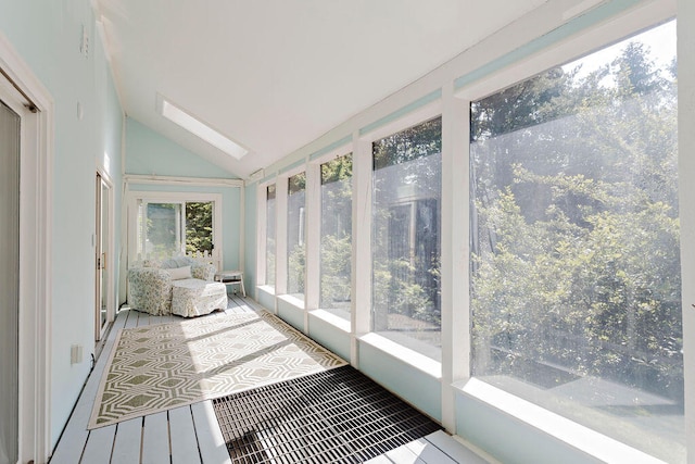 sunroom / solarium with lofted ceiling with skylight