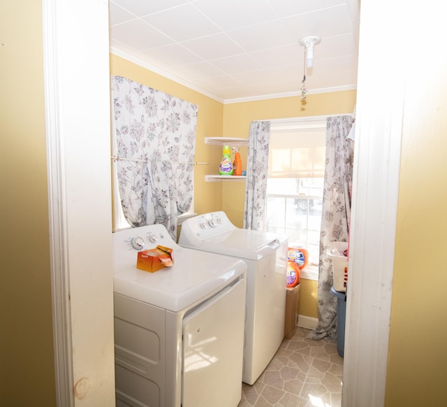 laundry room featuring light tile patterned flooring, crown molding, and separate washer and dryer