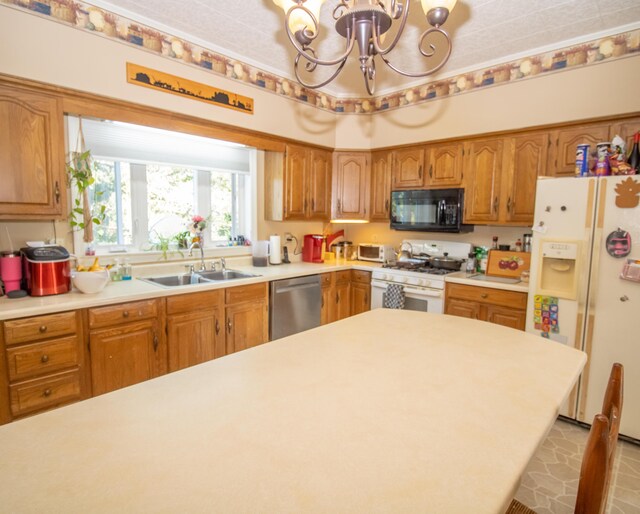 kitchen with sink, white appliances, and a chandelier