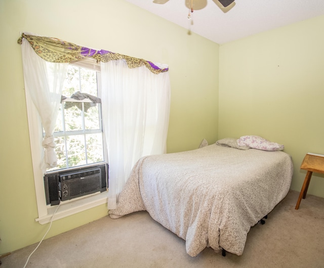 carpeted bedroom featuring cooling unit and ceiling fan