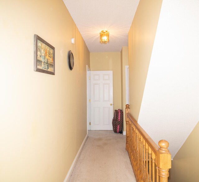 corridor with light colored carpet