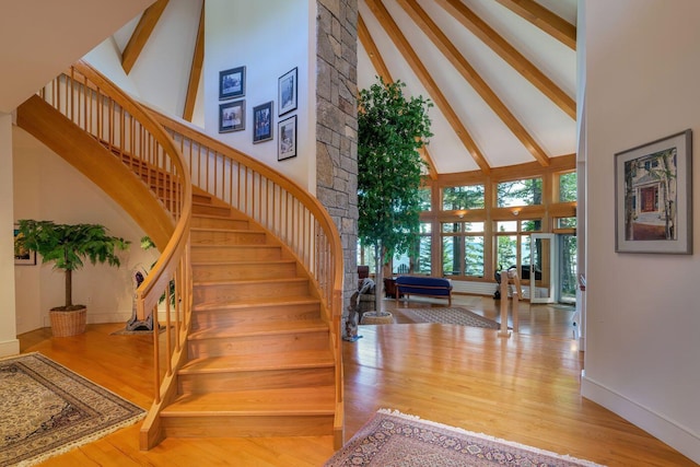 interior space featuring hardwood / wood-style flooring, high vaulted ceiling, and beam ceiling