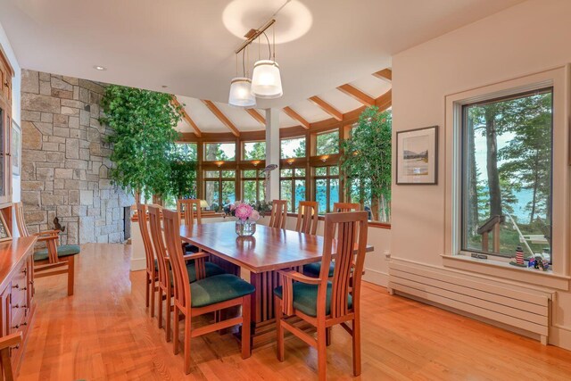 dining area featuring lofted ceiling with beams and a healthy amount of sunlight