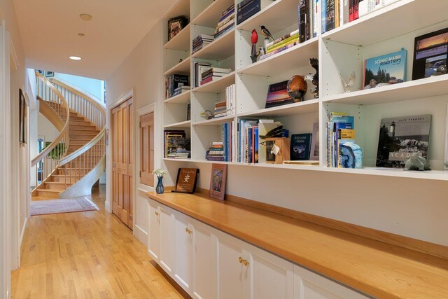 corridor with light hardwood / wood-style floors