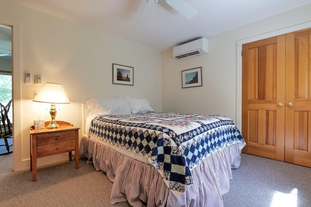 bedroom featuring a closet, ceiling fan, a wall unit AC, and light carpet