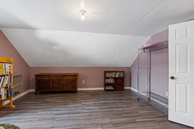 additional living space with vaulted ceiling and wood-type flooring