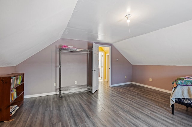 bonus room with lofted ceiling and dark hardwood / wood-style floors