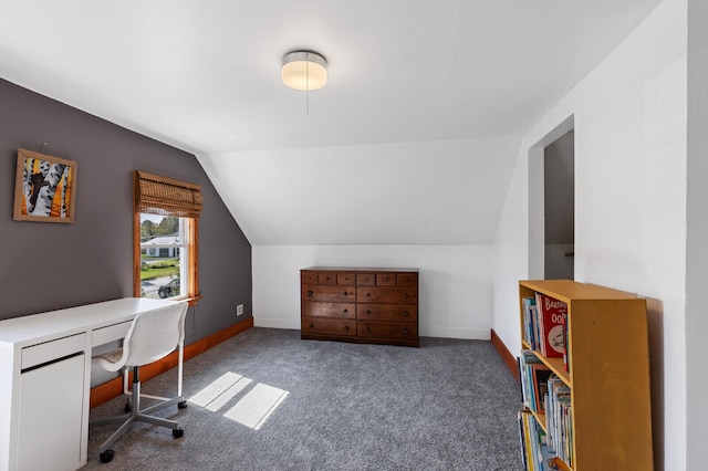 office with lofted ceiling and dark carpet