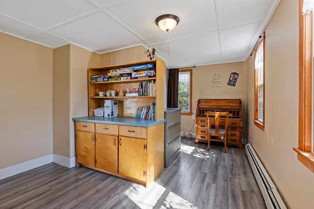 kitchen featuring baseboard heating and dark hardwood / wood-style floors