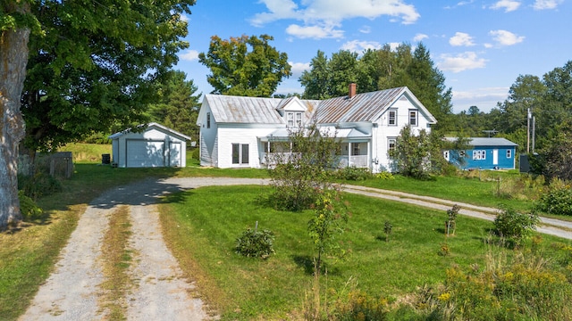 view of front facade with a garage, covered porch, an outdoor structure, and a front yard