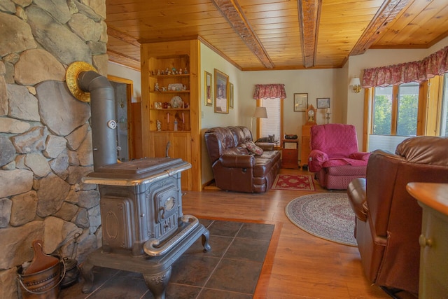 living room featuring wood ceiling, a wood stove, and wood-type flooring