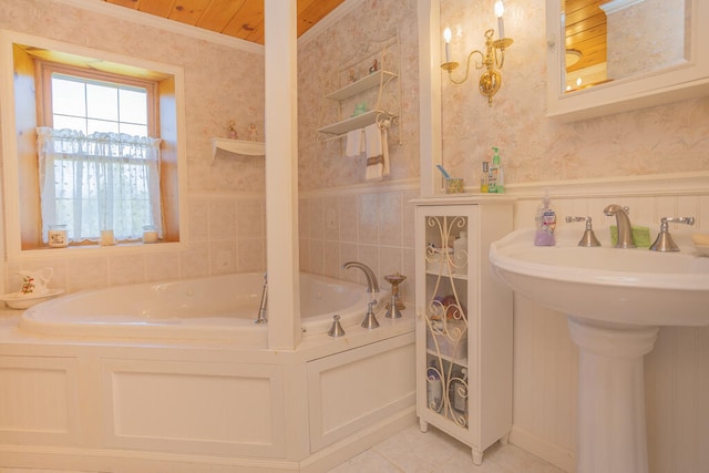 bathroom featuring ornamental molding, a bath, sink, and tile patterned flooring