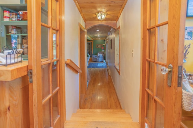 corridor with wood ceiling, hardwood / wood-style flooring, and ornamental molding