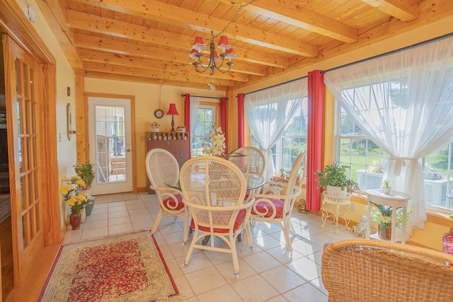 tiled dining area featuring wooden ceiling, a healthy amount of sunlight, a chandelier, and beam ceiling