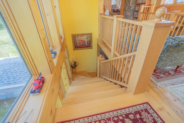 stairs featuring hardwood / wood-style floors