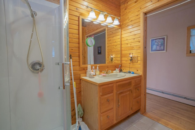 bathroom with tile patterned flooring, wooden walls, walk in shower, a baseboard radiator, and vanity