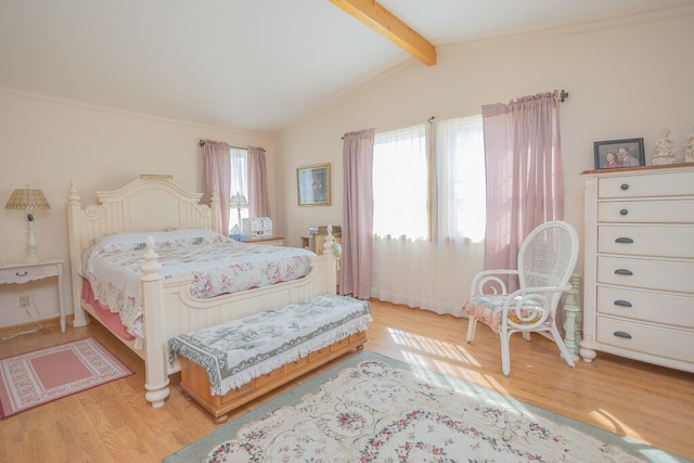 bedroom featuring light wood-type flooring and vaulted ceiling with beams