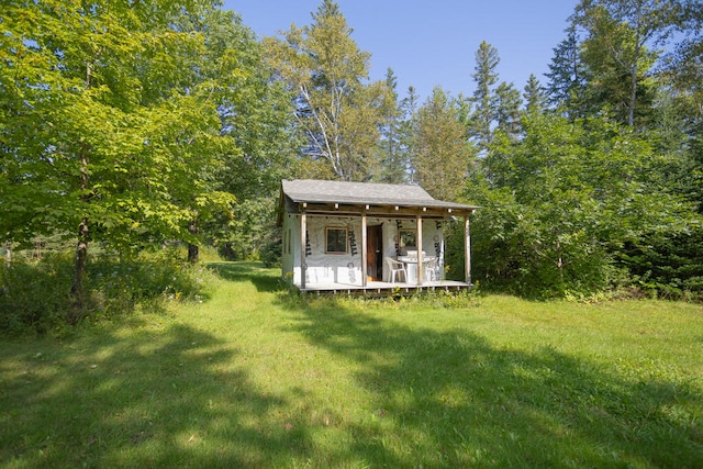 exterior space featuring an outdoor structure and a front yard