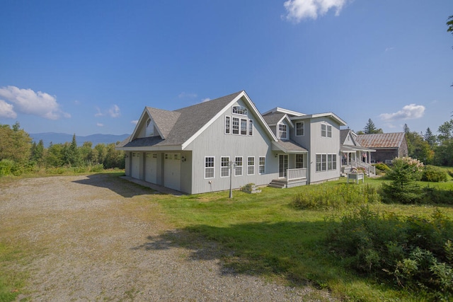 view of side of home with a garage and a yard