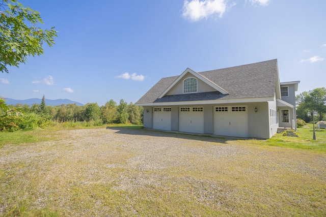 garage featuring a yard and a mountain view