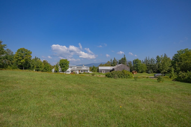 view of yard with a rural view