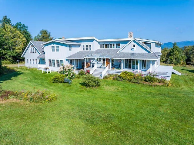 view of front of house with a front yard and a porch